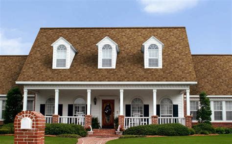 tan brick house with blue facia boards and metal roof|tan and white house colors.